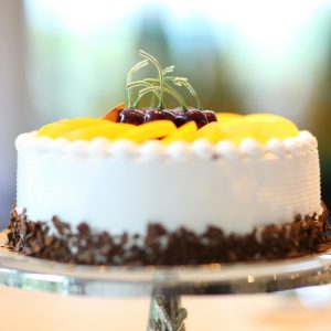 White Round Cake Topped With Yellow Slice Fruit